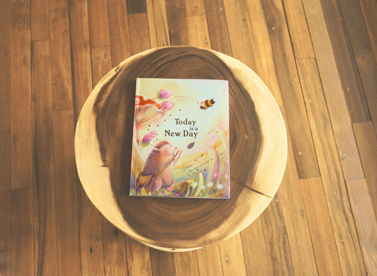 Book titled 'Today is a New Day' on a wooden surface.